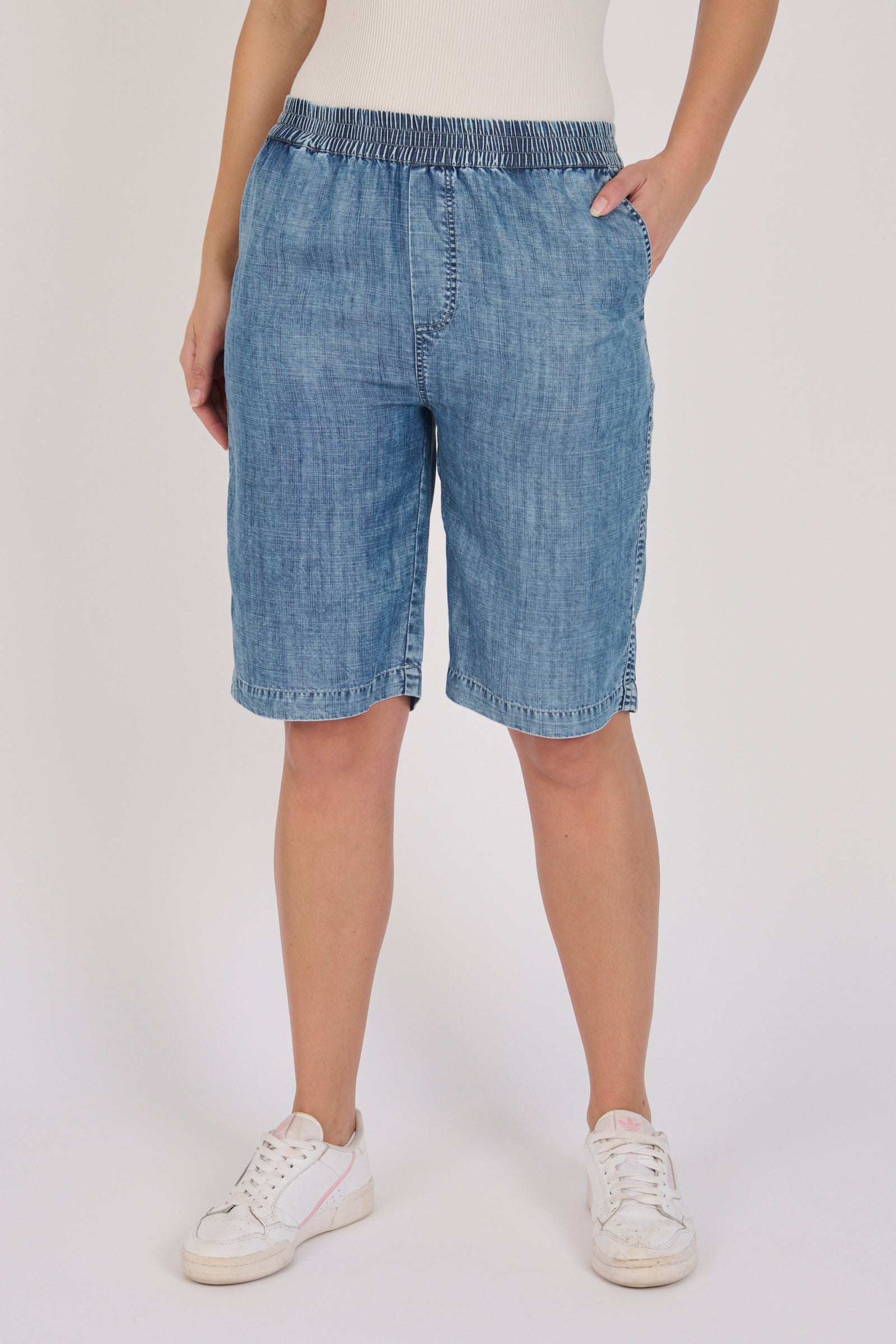Pull-On Longline Short in dark blue lyocell with knee-length cut and side pockets.