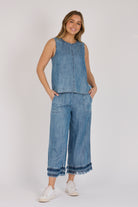 Model wearing a dark blue 100% lyocell swing top with contrast seam detailing.