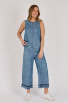 Model wearing a dark blue 100% lyocell swing top with contrast seam detailing.