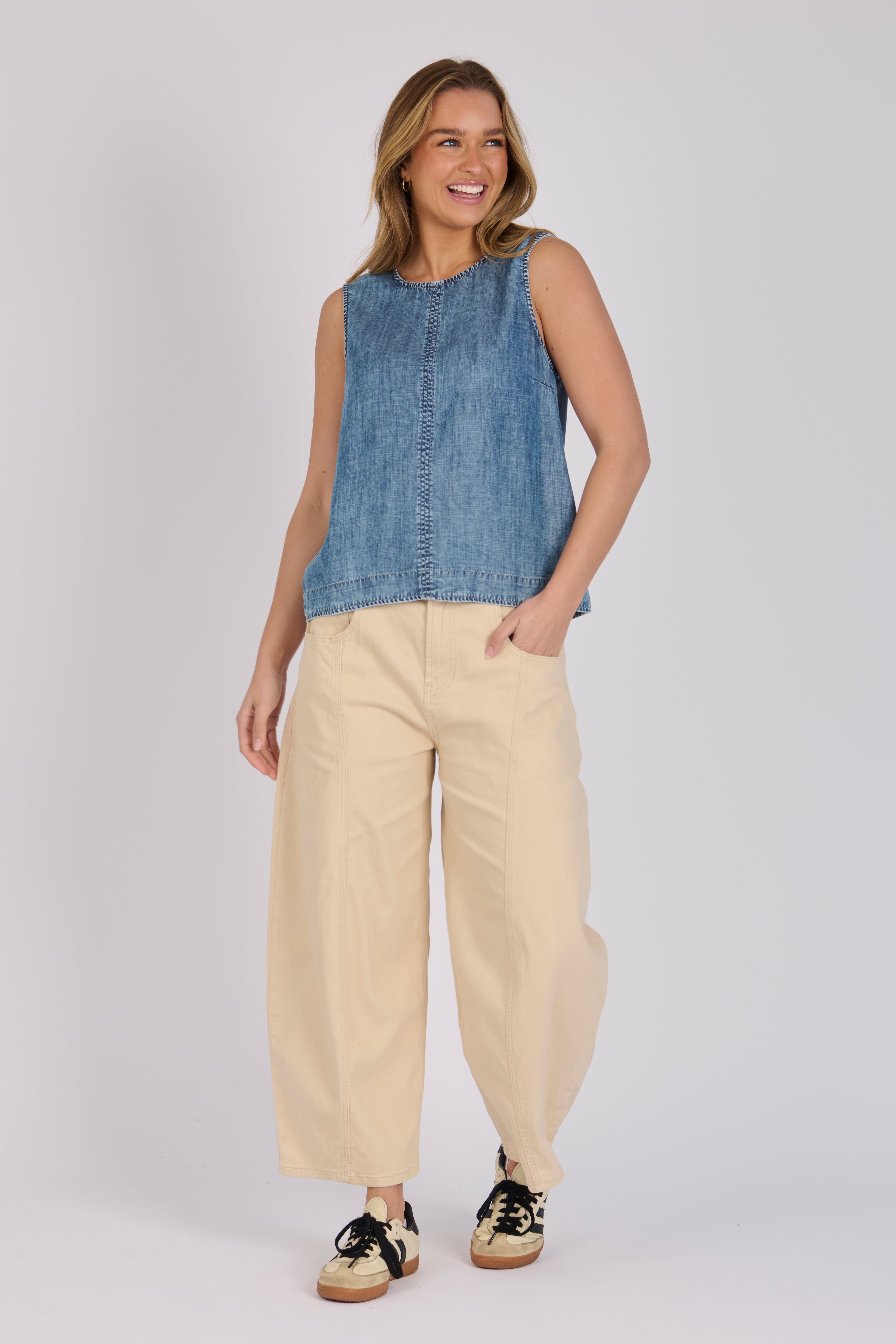 Model wearing a dark blue 100% lyocell swing top with contrast seam detailing.