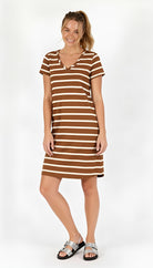 Woman wearing a acorn and white striped dress on a white background